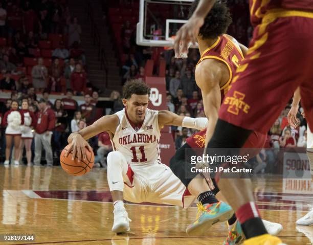 Trae Young of the Oklahoma Sooners works his way around Lindell Wigginton of the Iowa State Cyclones during the second half of a NCAA college...