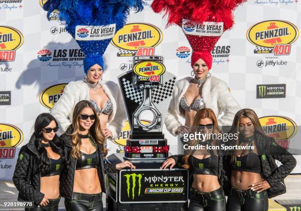 Las Vegas Show and Monster Energy models pose with the winner's trophy after the Monster Energy NASCAR Cup Series Pennzoil 400 on March 4 at the Las...