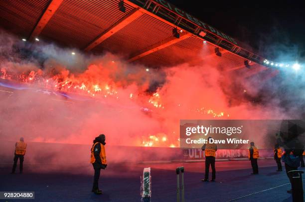 Fans of PSG lights up flares during the UEFA Champions League Round of 16 Second Leg match between Paris Saint Germain and Real Madrid at Parc des...