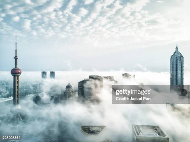 aerial view of shanghai lujiazui financial district in fog - business air travel photos et images de collection