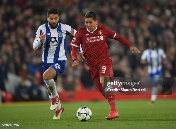 Roberto Firmino of Liverpool is challenged by Felipe of FC Porto during the UEFA Champions League Round of 16 second leg match between Liverpool and...