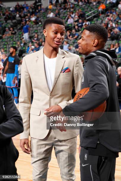 Dozier of the Oklahoma City Thunder talks with Dennis Smith Jr. #1 of the Dallas Mavericks prior to the game between the two teams on February 28,...