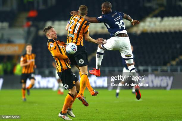 Tom Elliott of Millwall FC wins a header from Michael Dawson as teammate Angus MacDonald challenges during the Sky Bet Championship match between...