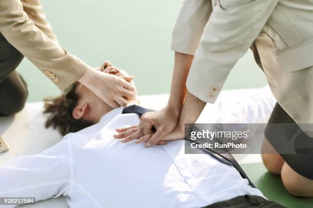 businesswoman performing cardiopulmonary resuscitation - emergency department stock pictures, royalty-free photos & images