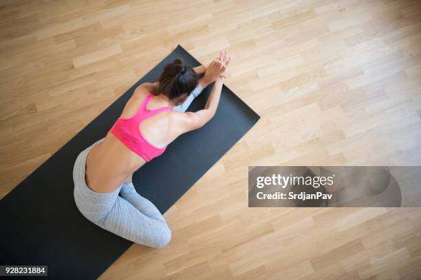 strength, recover and tone - child yoga elevated view stock pictures, royalty-free photos & images