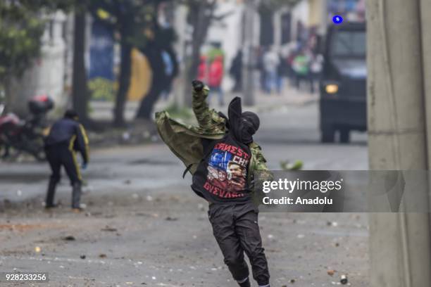 Protestors throw rocks at riot police attempt after clashes broke out between students and riot police during a protest due to dissatisfaction of...