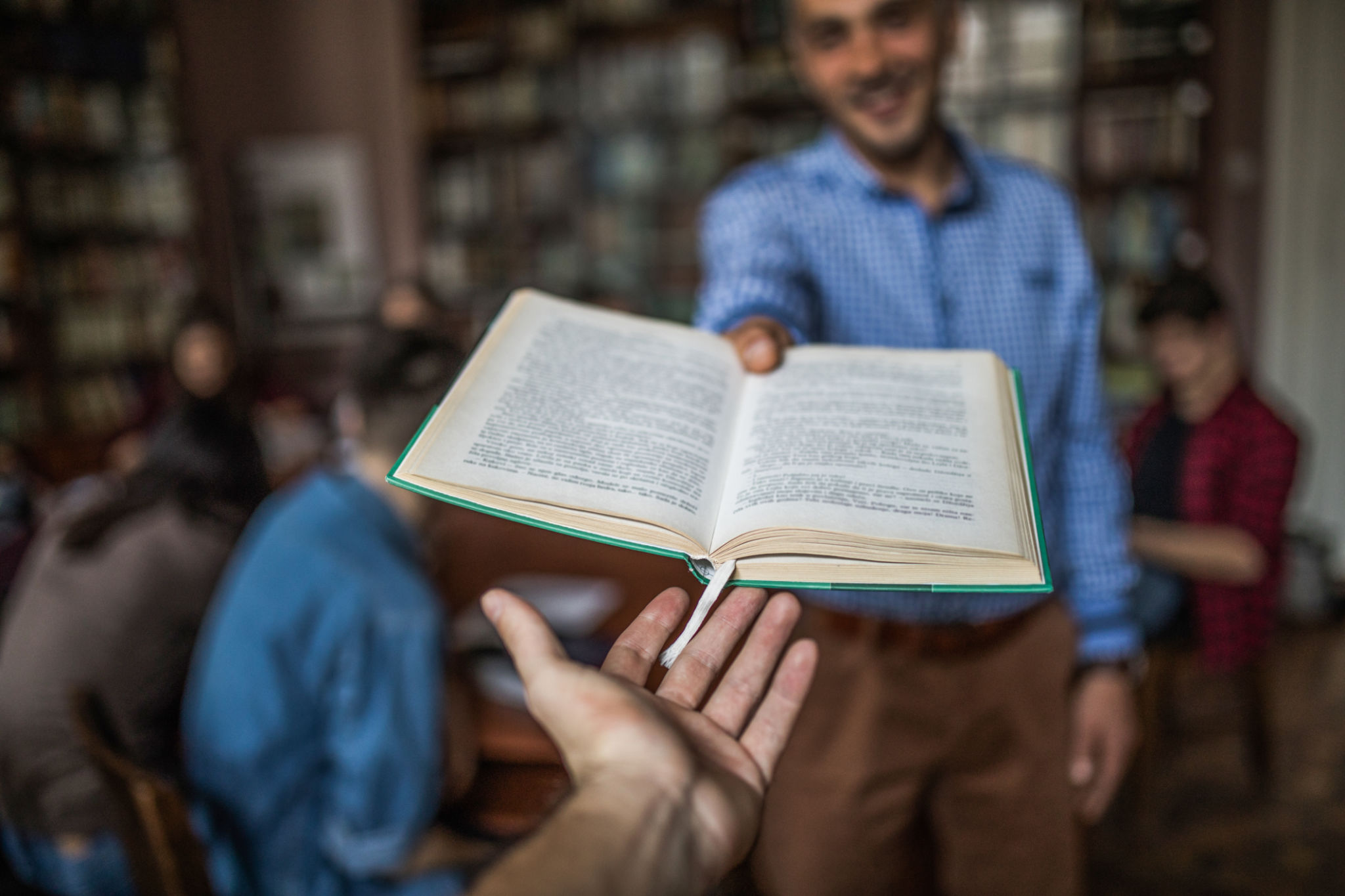 Close up of taking a book from a professor. Close up of taking a book from a professor.