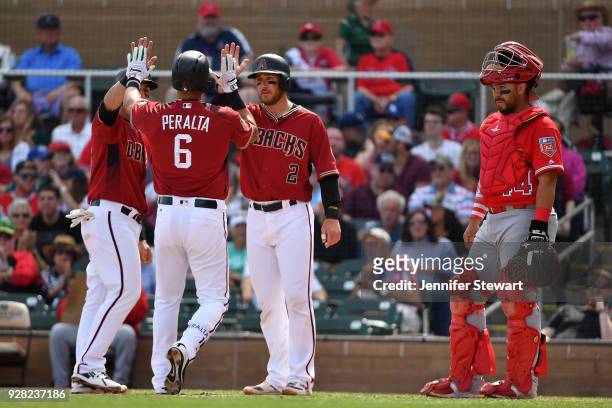 David Peralta of the Arizona Diamondbacks is congratulated by Daniel Descalso and Jeff Mathis after hitting a three run home run against the Los...