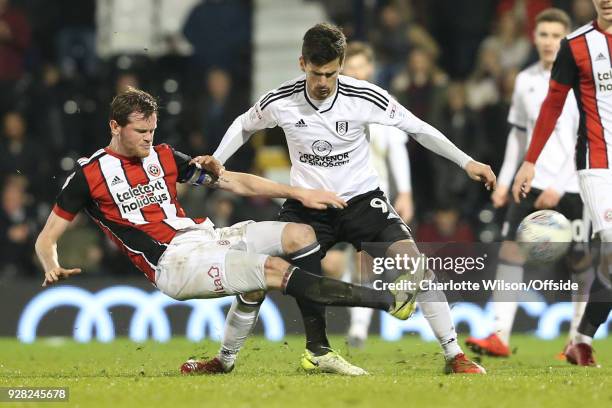 Richard Stearman of Sheffield United kicks the ball out of play in front of Rui Fonte of Fulham during the Sky Bet Championship match between Fulham...