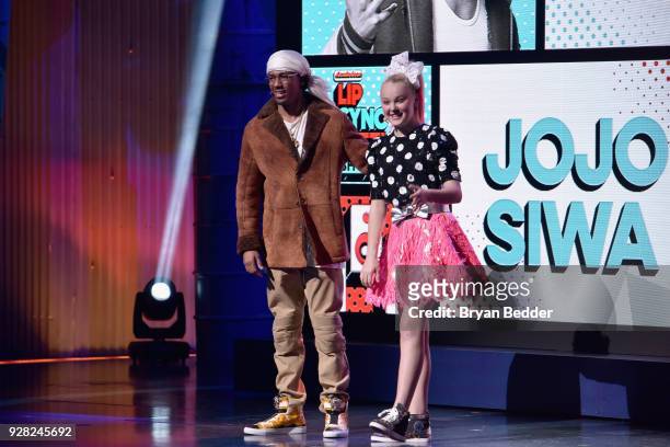 Nick Cannon and JoJo Siwa speak onstage at the Nickelodeon Upfront 2018 at Palace Theatre on March 6, 2018 in New York City.