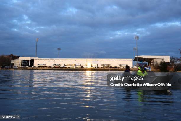 The evening sunlight flares off of Craven Cottage as a motorboat passes by on the River Thames ahead of the Sky Bet Championship match between Fulham...