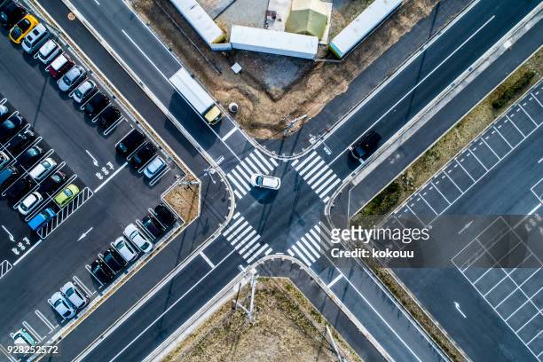 unmanned parking lot and parking lot where lots of cars are parked. - road intersection stock pictures, royalty-free photos & images