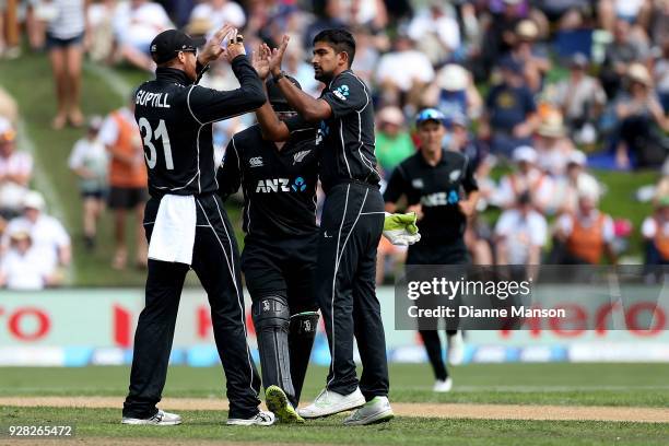 Martin Guptill and Ish Sodhi of New Zealand celebrate the dismissal of Josh Buttler of England during game four of the One Day International series...