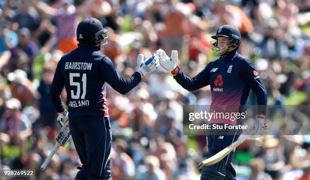 England batsman Joe Root congratulates century maker Jonny Bairstow during the 4th ODI between New Zealand and England at University of Otago Oval on...