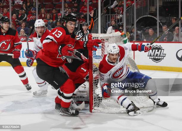 Nico Hischier of the New Jersey Devils skates against Andrew Shaw of the Montreal Canadiens during the first period at the Prudential Center on March...