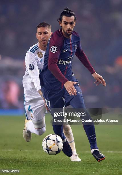 Javier Pastore of Paris Saint-Germain competes for the ball with Sergio Ramos of Real Madrid during the UEFA Champions League Round of 16 Second Leg...
