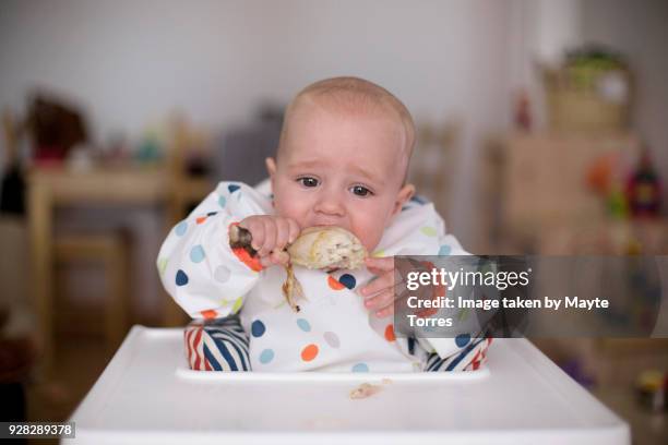 baby boy eating chicken - baby chicken bildbanksfoton och bilder