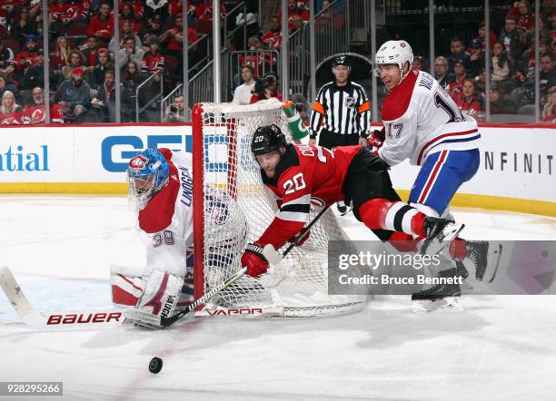 Skating in his first NHL game, Rinat Valiev of the Montreal Canadiens checks Blake Coleman of the New Jersey Devils during the second period at the...