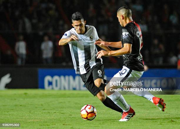 Carlos Castro of Venezuela's Zamora and Cristian Guanca of Argentina's Colon vie for the ball during their Copa Sudamericana football match at the...