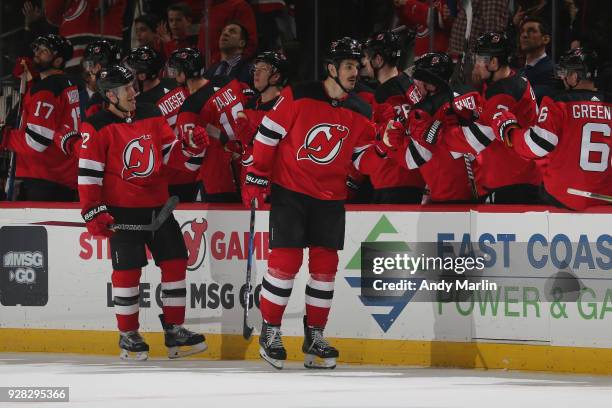 Brian Boyle and Ben Lovejoy of the New Jersey Devils celebrate Boyle's second period goal during the game against the Montreal Canadiens at...