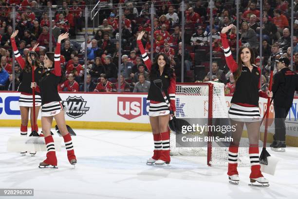 The Chicago Blackhawks ice-crew waves to the crowd during the game between the Chicago Blackhawks and the Colorado Avalanche at the United Center on...