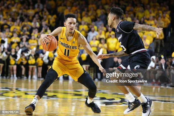 Wichita State Shockers guard Landry Shamet puts a move on Cincinnati Bearcats guard Cane Broome in the second half of an American Athletic Conference...