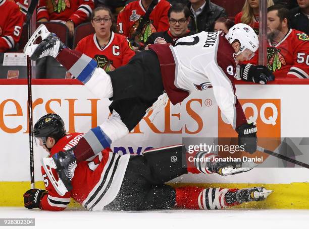 Gabriel Landeskog of the Colorado Avalanche and Connor Murphy of the Chicago Blackhawks get tangled up along the boards at the United Center on March...