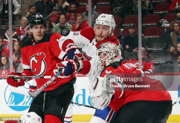 Nicolas Deslauriers of the Montreal Canadiens attempts to deflect a shot past Keith Kinkaid of the New Jersey Devils during the third period at the...