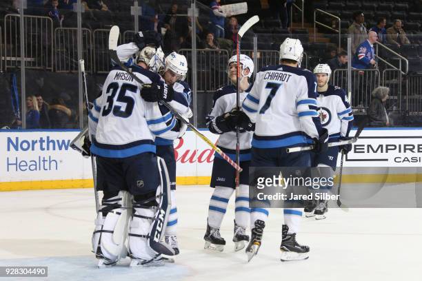 Steve Mason of the Winnipeg Jets celebrates with teammates after defeating the New York Rangers 3-0 at Madison Square Garden on March 6, 2018 in New...