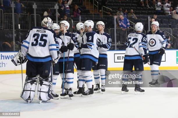 Steve Mason of the Winnipeg Jets celebrates with teammates after defeating the New York Rangers 3-0 at Madison Square Garden on March 6, 2018 in New...