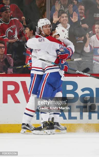 Jacob De La Rose of the Montreal Canadiens is congratulated by Andrew Shaw after scoring a goal during the game against the New Jersey Devils at...