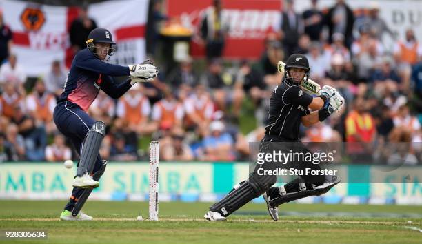 New Zealand batsman Ross Taylor hits out watched by Jos Buttler during the 4th ODI between New Zealand and England at University of Otago Oval on...