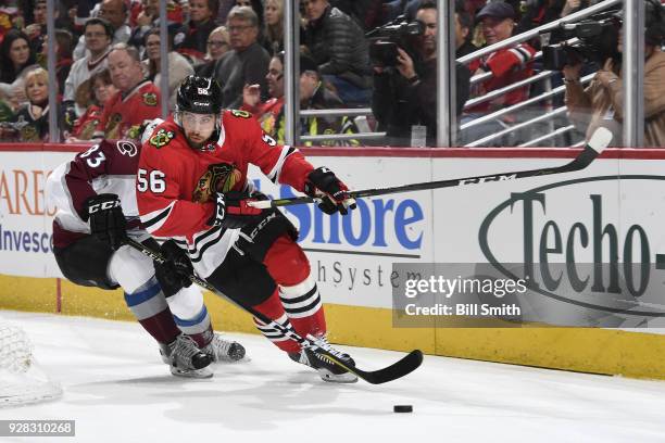 Erik Gustafsson of the Chicago Blackhawks approaches the puck ahead of Matt Nieto of the Colorado Avalanche in the second period at the United Center...