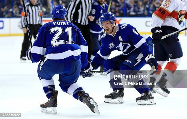 Brayden Point of the Tampa Bay Lightning is congratulated by Anton Stralman after scoring the game winning goal in overtime during a game against the...