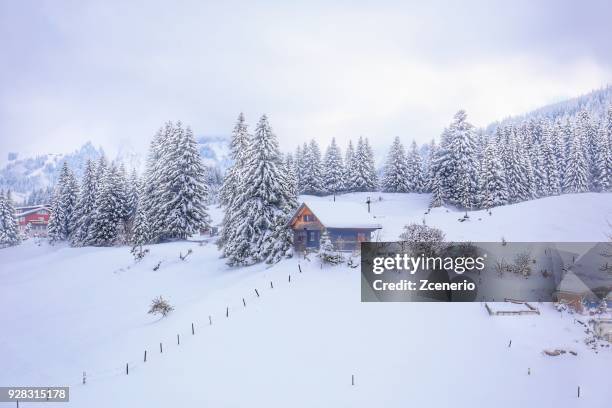 winter white landscape of traditional swiss house coverd with snow on the way in cable car up to titlis mount, engelberg, canton of bern, switzerland - snow coverd stock pictures, royalty-free photos & images