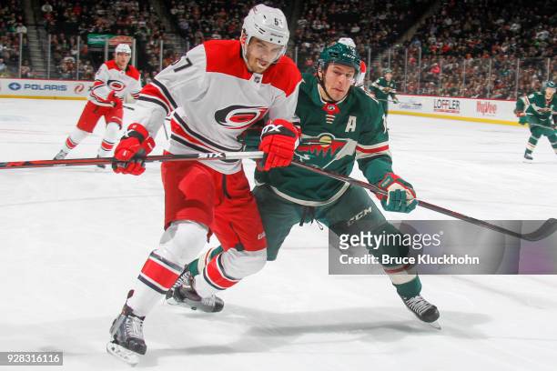 Zach Parise of the Minnesota Wild and Trevor van Riemsdyk of the Carolina Hurricanes skate to the puck during the game at the Xcel Energy Center on...