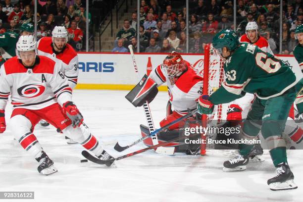 Jeff Skinner, Phil Di Giuseppe and goalie Scott Darling of the Carolina Hurricanes defend their goal against Tyler Ennis of the Minnesota Wild during...