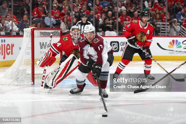 Tyson Jost of the Colorado Avalanche reaches for the puck in front of goalie J-F Berube of the Chicago Blackhawks in the third period at the United...