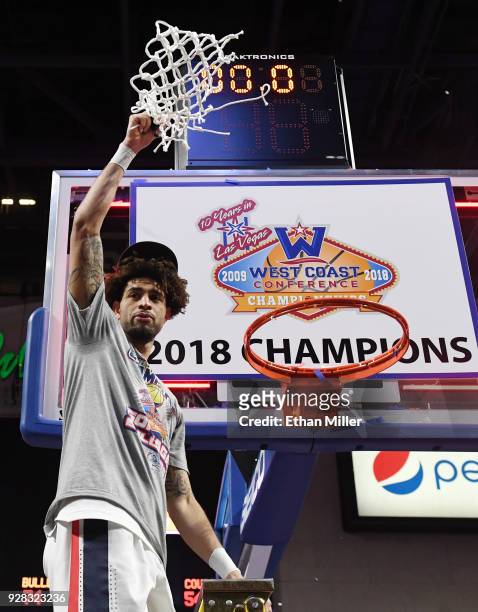 Josh Perkins of the Gonzaga Bulldogs cuts down a net after defeating the Brigham Young Cougars 74-54 to win the championship game of the West Coast...