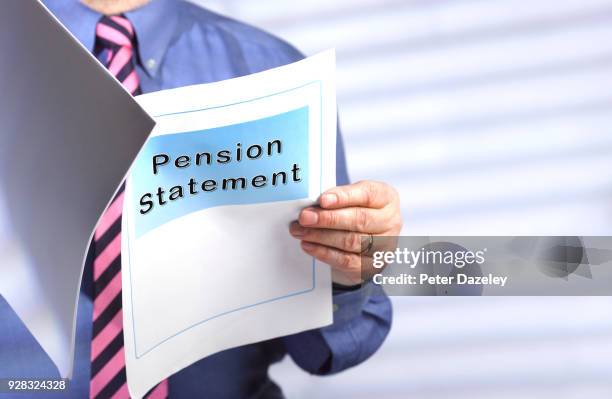 businessman reading pension statement - human body part stock pictures, royalty-free photos & images