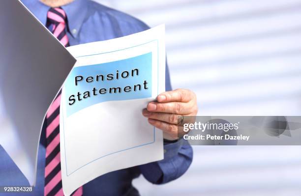 businessman reading pension statement - human age stock pictures, royalty-free photos & images