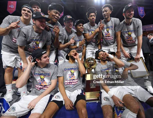 The Gonzaga Bulldogs celebrate with the trophy after defeating the Brigham Young Cougars 74-54 to win the championship game of the West Coast...