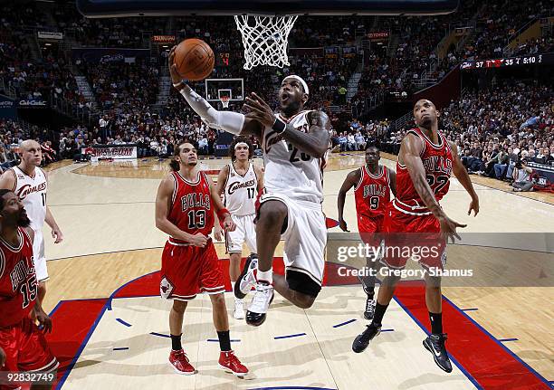 LeBron James of the Cleveland Cavaliers gets to the basket between Joakim Noah and Taj Gibson of the Chicago Bulls on November 5, 2009 at the Quicken...