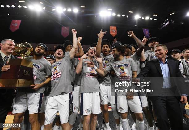 The championship trophy is handed to the Gonzaga Bulldogs players and head coach Mark Few after they defeated the Brigham Young Cougars 74-54 to win...