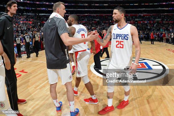 Sam Dekker and Austin Rivers of the LA Clippers exchange handshakes after the game against the Brooklyn Nets on March 4, 2018 at STAPLES Center in...