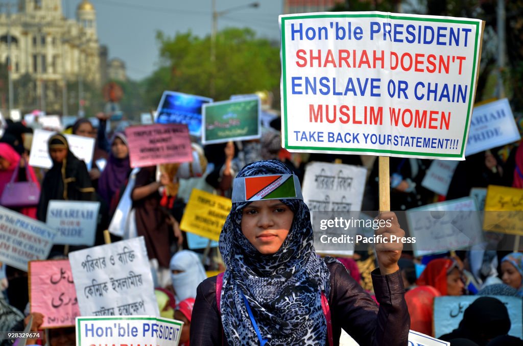 Indian Muslim women's hold placards and take part in a...