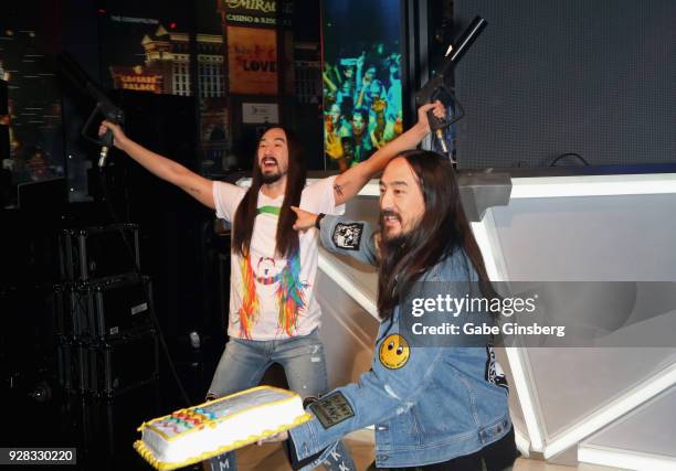 Producer Steve Aoki prepares to throw a cake at his new wax figure at Madame Tussauds Las Vegas at The Venetian on March 6, 2018 in Las Vegas, Nevada.