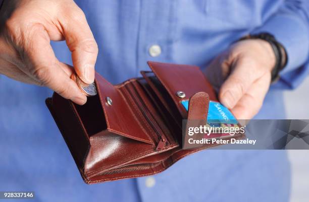 coins and savings wallet - saving for a rainy day englische redewendung stock-fotos und bilder