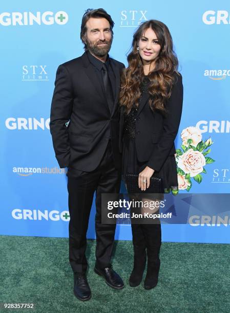 Sharlto Copley and Tanit Phoenix attend the Los Angeles Premiere "Gringo" at Regal LA Live Stadium 14 on March 6, 2018 in Los Angeles, California.