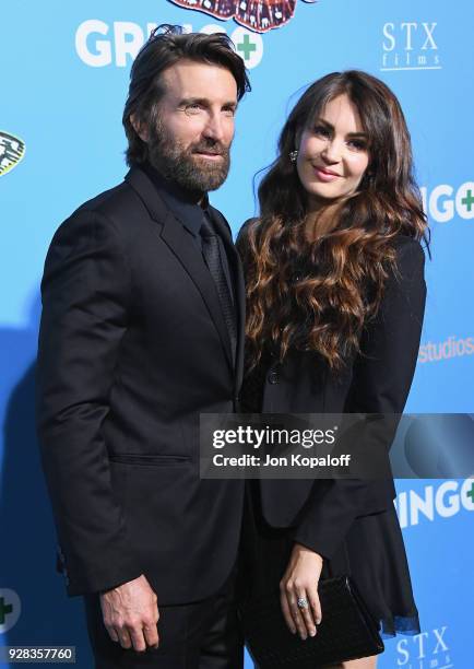 Sharlto Copley and Tanit Phoenix attend the Los Angeles Premiere "Gringo" at Regal LA Live Stadium 14 on March 6, 2018 in Los Angeles, California.